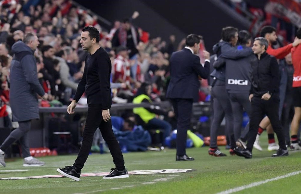 Barcelona's head coach Xavi Hernandez walks as Atlhletic Bilbao scores its second goal during the Copa del Rey quarterfinals soccer match between Athletic Bilbao and Barcelona at the San Mames stadium in Bilbao, Spain, on Wednesday, Jan. 24, 2024. (AP Photo/Alvaro Barrientos)