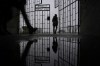 A person enters the Sachsenhausen Nazi death camp through the gate with the phrase 'Arbeit macht frei' (work sets you free) in Oranienburg, Germany, on Jan. 25, 2022. The world marks International Holocaust Remembrance Day on Saturday.THE CANADIAN PRESS/AP-Markus Schreiber