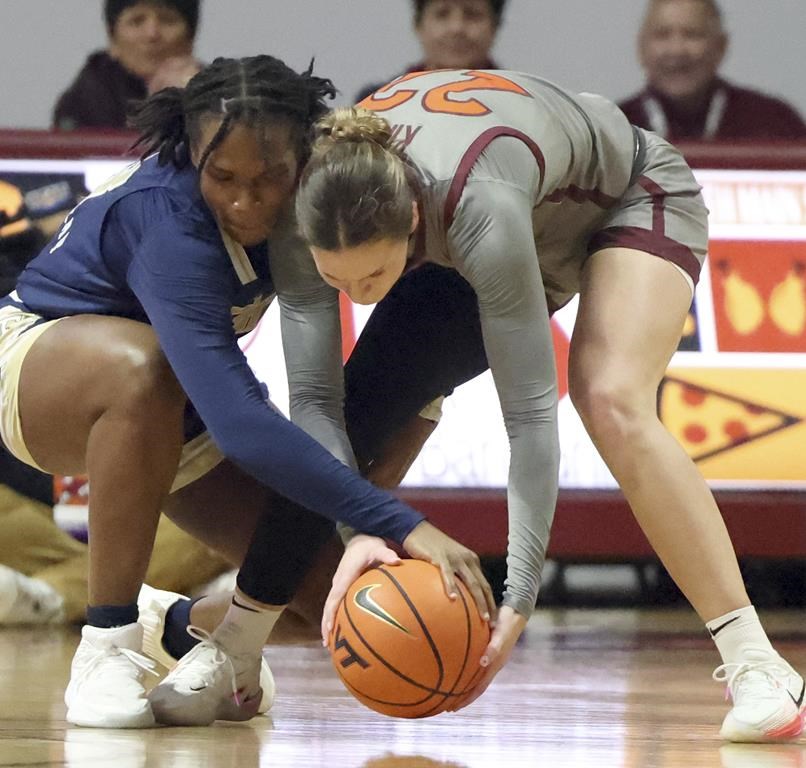 Georgia Tech's Kayla Blackshear, left, and Virginia Tech's Cayla King (22) battle for the ball in the first half of an NCAA college basketball game Thursday, Jan. 25, 2024, in Blacksburg, Va. (Matt Gentry/The Roanoke Times via AP)