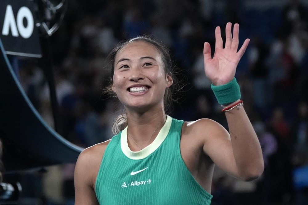 Zheng Qinwen of China celebrates after defeating Dayana Yastremska of Ukraine in semifinal match at the Australian Open tennis championships at Melbourne Park, Melbourne, Australia, Thursday, Jan. 25, 2024. (AP Photo/Alessandra Tarantino)