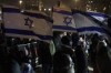 Holding up Israeli flags people take part in a protest against humanitarian aid entering Gaza and against the hostages exchange deal with Hamas, in Jerusalem, Israel, Thursday, Jan. 25, 2024. (AP Photo/Leo Correa)