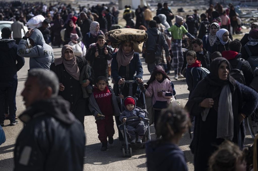 Palestinians arrive in the southern Gaza town of Rafah after fleeing an Israeli ground and air offensive in the nearby city of Khan Younis on Friday, Jan. 26, 2024. Israel has expanded its offensive in Khan Younis, saying the city is a stronghold of the Hamas militant group. (AP Photo/Fatima Shbair)