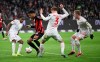 Frankfurt's Ansgar Knauff, second from left, challenges for the ball with Mainz's Leandro Barreiro Martins, left, Sepp van den Berg, centre right, and Jonathan Burkhardt during the German Bundesliga soccer match between Eintracht Frankfurt and 1. FSV Mainz 05 at Deutsche Bank Park Stadium in Frankfurt, Germany, Friday, Jan. 26, 2024. (Arne Dedert/dpa via AP)
