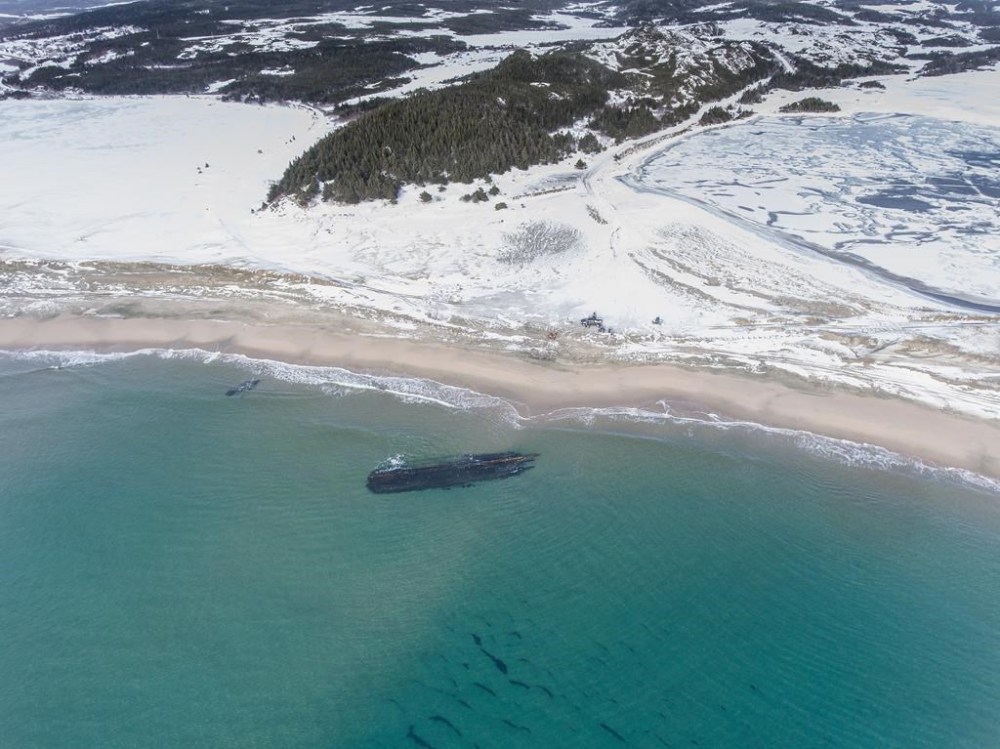 The massive, overturned hull of a seemingly ancient ship has appeared without warning along Newfoundland's southwestern tip as shown in this handout image provided by Corey Purchase. Wanda Blackmore says her 21-year-old son, Gordon, came roaring into her house last Saturday morning after spotting the long shadow beneath the water just off the beach in Cape Ray, N.L.THE CANADIAN PRESS/HO-Corey Purchase
**MANDATORY CREDIT**