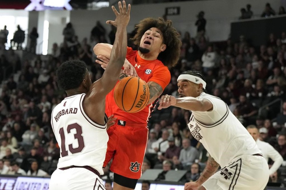 Auburn guard Tre Donaldson (3) has the ball knocked away by Mississippi State guard Josh Hubbard (13) during the first half of an NCAA college basketball game, Saturday, Jan. 27, 2024, in Starkville, Miss. (AP Photo/Rogelio V. Solis)