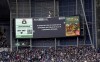 The stadium's big screen displays a message asking for fans to return to their seats , during the English FA Cup fourth round soccer match between West Bromwich Albion and Wolverhampton Wanderers, at The Hawthorns, in West Bromwich, England, Sunday, Jan. 28, 2024. (Bradley Collyer/PA via AP)