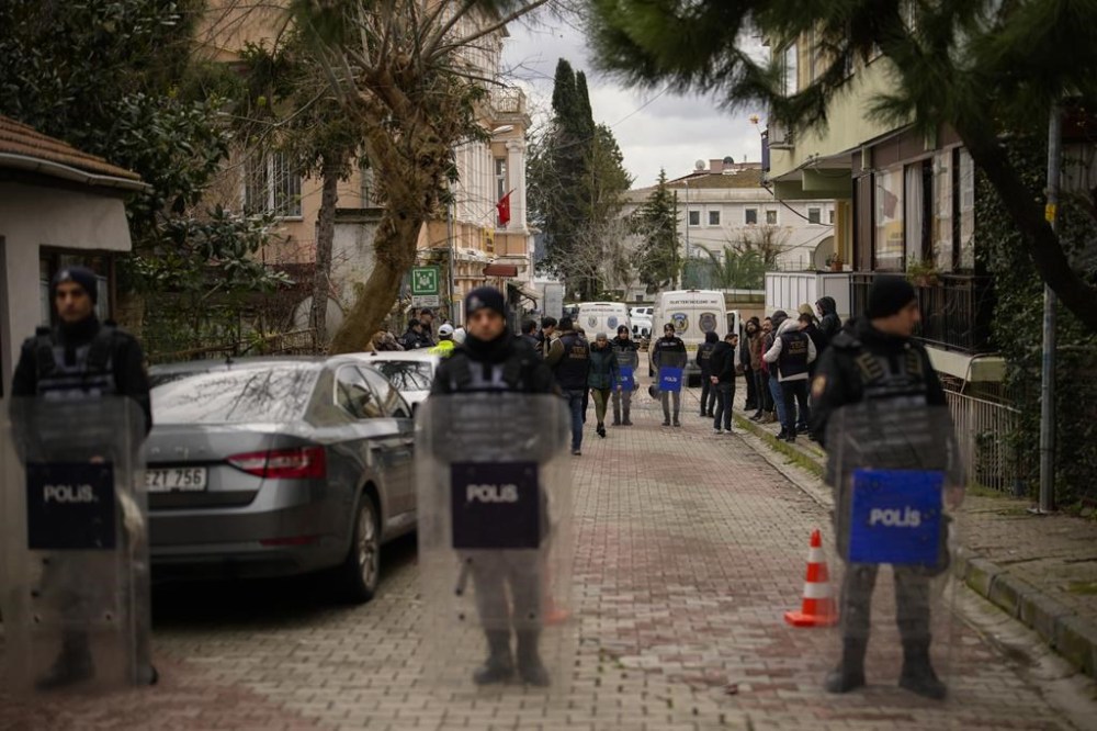 Turkish police officers stand guard in a cordoned off area outside Santa Maria church in Istanbul, Turkey, Sunday, Jan. 28, 2024. Two masked assailants attacked a church in Istanbul during Sunday services, killing one person, Turkish officials said. (AP Photo/Emrah Gurel)