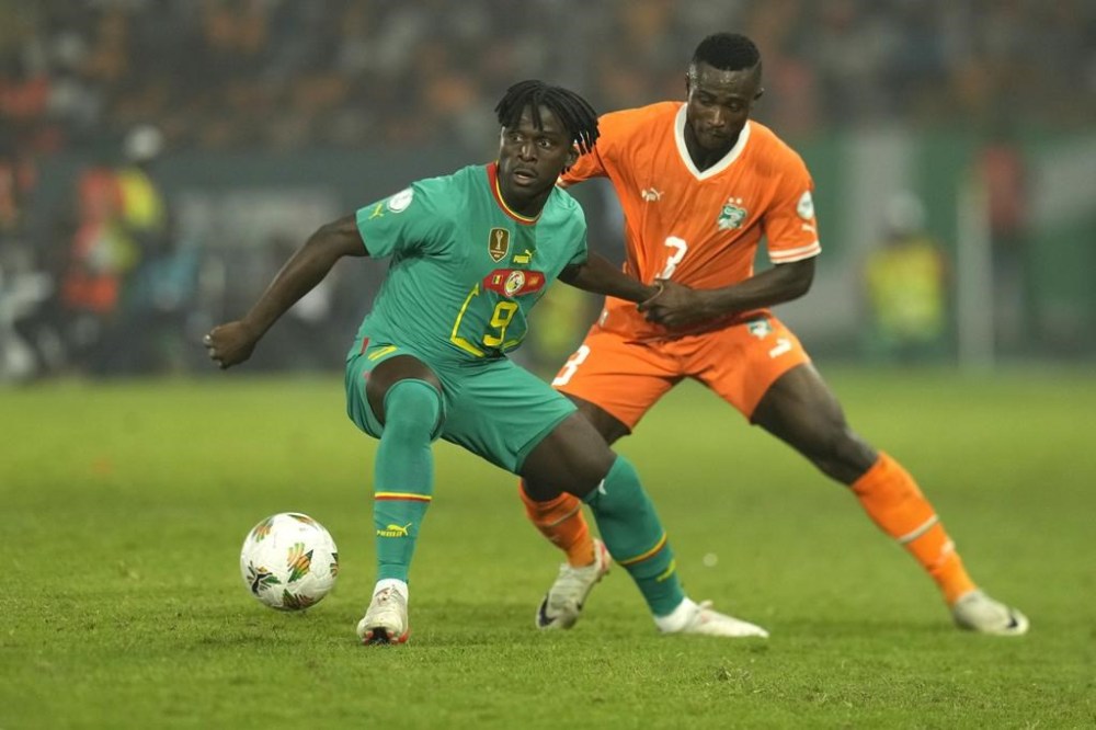 Senegal's Cheikh Ahmadou Bamba Dieng, left, challenges for the ball with Ivory Coast's Ghislain Konan during the African Cup of Nations round of 16 soccer match between Senegal and Ivory Coast, at the Charles Konan Banny stadium in Yamoussoukro, Ivory Coast, Monday, Jan. 29, 2024. (AP Photo/Themba Hadebe)