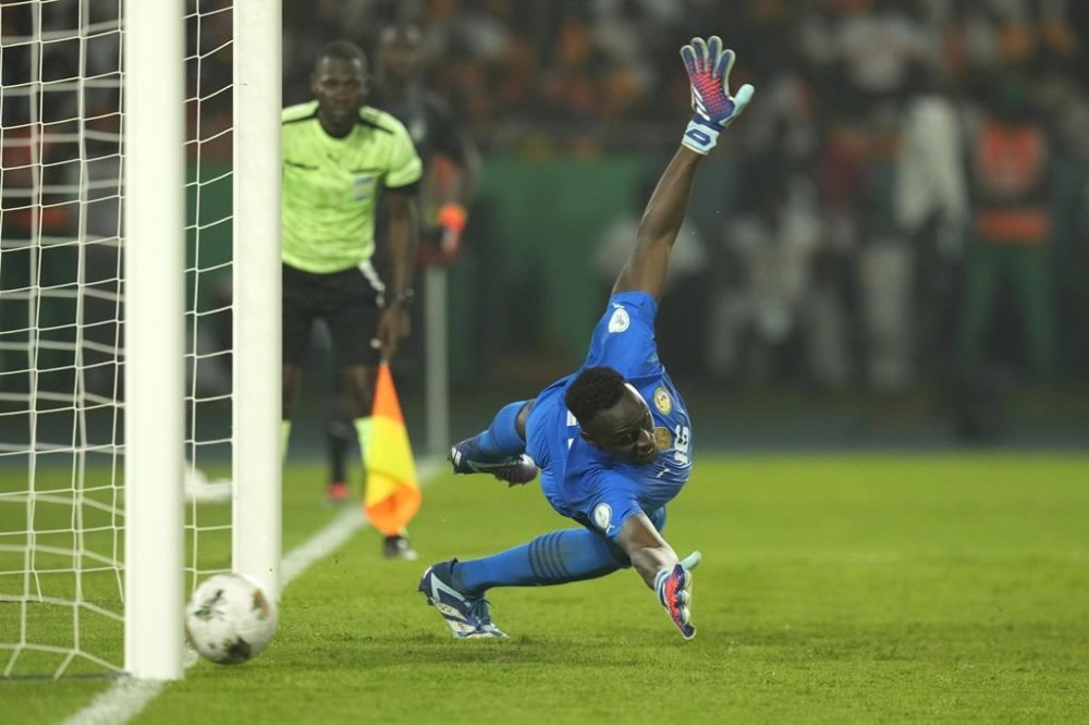 Senegal's goalkeeper Edouard Mendy dives but fails to save the goal from Ivory Coast's Nicolas Pepe during the penalty shootout during the African Cup of Nations round of 16 soccer match between Senegal and Ivory Coast, at the Charles Konan Banny stadium in Yamoussoukro, Ivory Coast, Saturday, Jan. 20, 2024. (AP Photo/Themba Hadebe)