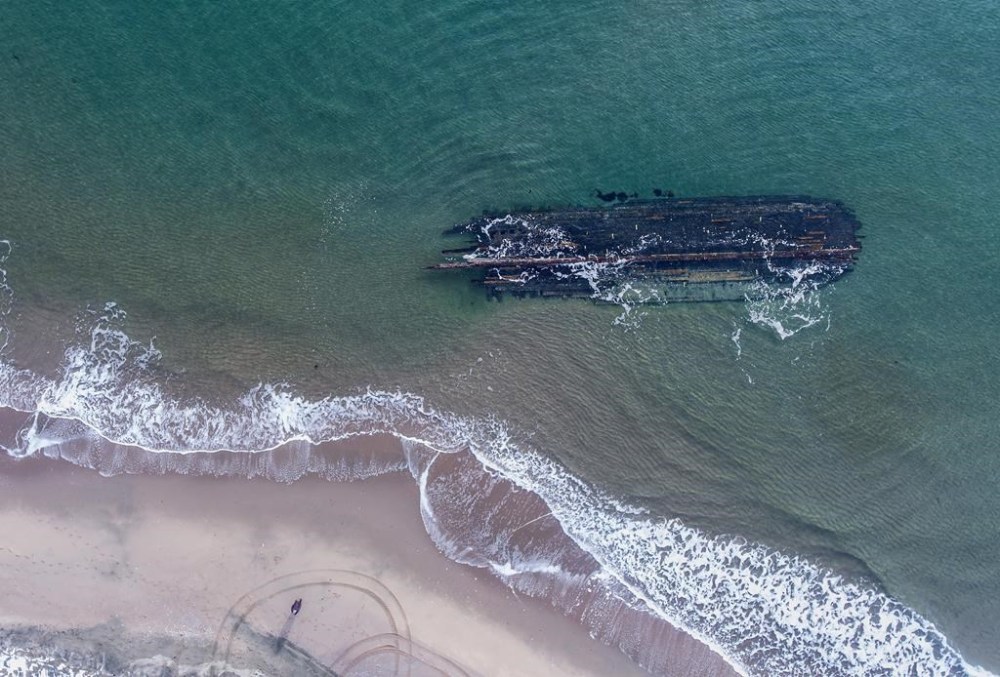 The massive, overturned hull of a seemingly ancient ship has appeared without warning along Newfoundland's southwestern tip as shown in a handout image provided by Corey Purchase. A man in southwestern Newfoundland is worried a massive shipwreck that has captured the country’s imagination will be washed out to sea before experts can investigate where it came from. THE CANADIAN PRESS/HO-Corey Purchase **MANDATORY CREDIT**