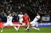 FILE - Israel's Sean Goldberg, left, and Israel's Raz Shlomo, right, challenge with Switzerland's Zeki Amdouni during the Euro 2024 group I qualifying soccer match between Israel and Switzerland at the Pancho Arena in Felcsut, Hungary, Nov. 15, 2023. The Israel men’s soccer team is going back to Hungary for a “home” game in the European Championship qualifying playoffs in March. Israel's game against Iceland must be played in a neutral country for security reasons during the conflict with Hamas. (AP Photo/Denes Erdos, File)