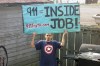 In this 2006 photo provided by Hector Tapia Perez Jr., his brother, Antonio Perez, holds a sign which reads 