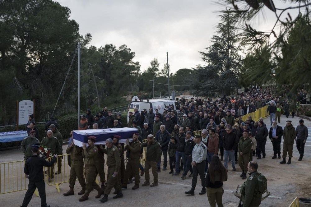 Israeli soldiers carry the flag-draped casket of reservist warrant officer Yuval Nir during his funeral at a cemetery in the West Bank settlement of Kfar Etzion, Israel, Wednesday, Jan. 31, 2024. Nir, 43, was killed during Israel's ground operation in the Gaza Strip, where the Israeli army has been battling Palestinian militants in the war ignited by Hamas' Oct. 7 attack into Israel. (AP Photo/Leo Correa)