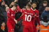 Liverpool's Conor Bradley, left, celebrates with his teammates after scoring his side's second goal during the English Premier League soccer match between Liverpool and Chelsea, at Anfield Stadium, Liverpool, England, Wednesday, Jan.31, 2024. (AP Photo/Jon Super)