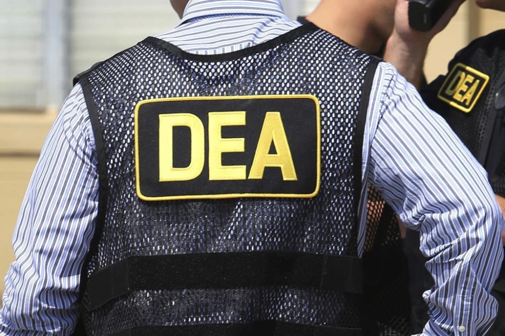 FILE - This June 13, 2016, file photo shows Drug Enforcement Administration agents in Florida. Federal prosecutors are expanding their investigation into a bribery scheme involving two former U.S. Drug Enforcement Administration supervisors, turning their attention to the two Miami defense attorneys suspected of profiting from repeated leaks of confidential DEA information. The U.S. Attorney's Office in Manhattan filed court papers Monday, Jan. 22, 2024, accusing the lawyers of bankrolling the scheme and asking a judge to allow prosecutors to review nearly 1,000 emails, text messages and recordings of protected phone calls between the attorneys and Manny Recio, a former DEA agent who later worked for the attorneys as a private investigator. (Joe Burbank/Orlando Sentinel via AP, File)