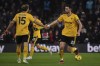 Wolverhampton Wanderers' Max Kilman, right, is congratulated by Wolverhampton Wanderers' Craig Dawson after scoring his side's second goal during the English Premier League soccer match between Wolverhampton Wanderers and Manchester United at the Molineux Stadium in Wolverhampton, England, Thursday, Feb. 1, 2024. (AP Photo/Rui Vieira)