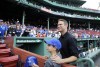 FILE - Theo Epstein, president of baseball operations for the Chicago Cubs, poses with a young fan prior to a baseball game between the Boston Red Sox and the Cubs at Fenway Park, Friday, April 28, 2017, in Boston. Epstein, who as Red Sox general manager was the architect of two World Series championships, is returning to the organization as a minority owner and part-time senior adviser to its parent company, Fenway Sports Group. (AP Photo/Elise Amendola, File)