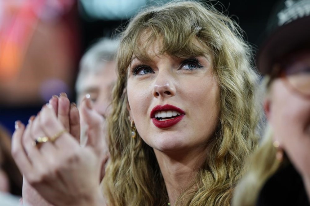 Taylor Swift, who recently became a prominent victim of deepfake pornography, stands on the field after an AFC Championship NFL football game between the Baltimore Ravens and the Kansas City Chiefs, Sunday, Jan. 28, 2024, in Baltimore. THE CANADIAN PRESS/AP-Julio Cortez