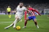 Real Madrid's Dani Carvajal, left, and Atletico Madrid's Mario Hermoso challenge for the ball during the Spanish La Liga soccer match between Real Madrid and Atletico Madrid at the Santiago Bernabeu stadium in Madrid, Spain, Sunday, Feb. 4, 2024. (AP Photo/Bernat Armangue)