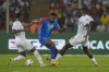 DR Congo's Cedric Bakambu, center, duels for the ball with Guinea's Mouctar Diakhaby, right, and Guinea's Amadou Diawara during the African Cup of Nations quarter final soccer match between DR Congo and Guinea, at the Olympic Stadium of Ebimpe in Abidjan, Ivory Coast, Friday, Feb. 2, 2024. (AP Photo/Themba Hadebe)