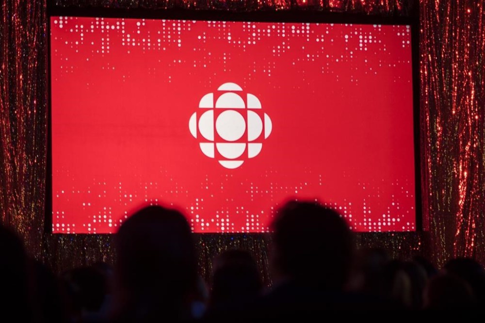 The CBC logo is projected onto a screen during the CBC's annual upfront presentation in Toronto on May 29, 2019. THE CANADIAN PRESS/Tijana Martin