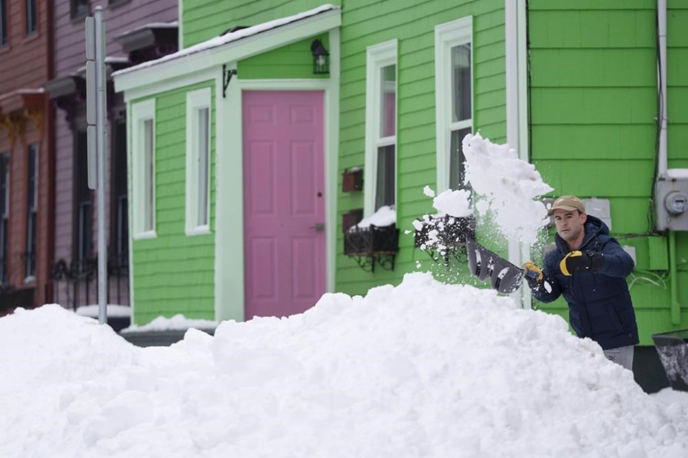 A person shovels snow in Halifax on Monday, February 5, 2024. Cleanup in Nova Scotia could take days after more than a metre of snow piled up in some parts of the province over the weekend. THE CANADIAN PRESS/Darren Calabrese