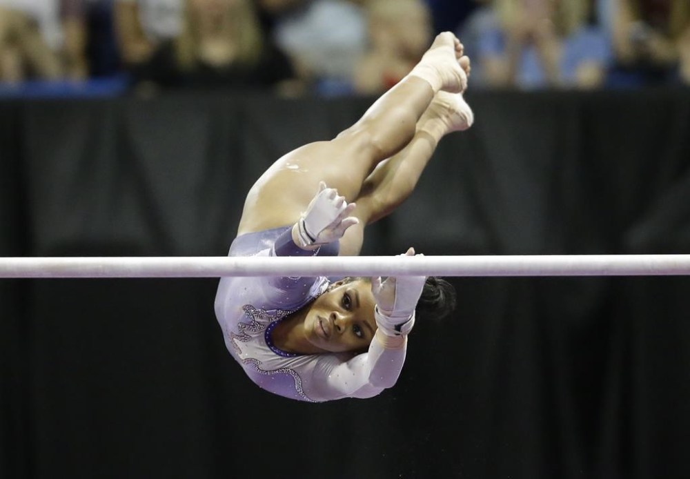 FILE -Gabby Douglas competes on the uneven bars during the U.S. women's gymnastics championships Sunday, June 26, 2016, in St. Louis.Douglas announced on Tuesday, Feb. 6, 2024 she will return to competition for the first time in nearly eight years when she competes at the Winter Cup in Louisville, Kentucky.