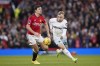 West Ham's Jarrod Bowen challenges for the ball with Manchester United's Harry Maguire during the English Premier League soccer match between Manchester United and West Ham United at the Old Trafford stadium in Manchester, England, Sunday, Feb. 4, 2024. (AP Photo/Dave Thompson)