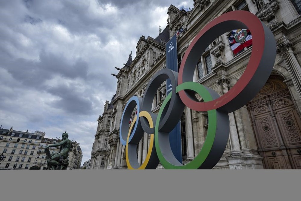 FILE - The Olympic rings are seen in front of the Paris City Hall, in Paris, on April 30, 2023. Olympic organizers will release tens of thousands of extra tickets for the Paris Games Thursday, Feb. 8, 2024 on the day they will unveil medals awarded to the top finishers. Organizers said the sale will start at 10 a.m. local time on the official ticketing website, with seats available for all sports. (AP Photo/Aurelien Morissard, File)