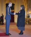 Britain's Prince William, the Prince of Wales, left, awards Karen Steen, Executive Head Teacher, Falkland Islands Schools, with the Commander of the Order of the British Empire, at Windsor Castle, Windsor, England, Wednesday, Feb. 7, 2024. The honour recognises services to education in the Falkland Islands. (Yui Mok/PA via AP)
