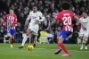 Real Madrid's Jude Bellingham, centre, controls the ball during the Spanish La Liga soccer match between Real Madrid and Atletico Madrid at the Santiago Bernabeu stadium in Madrid, Spain, Sunday, Feb. 4, 2024. (AP Photo/Bernat Armangue)