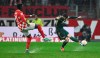 Mainz's Danny Da Costa, left,and Union's Robin Gosens fight for the ball during the German Bundesliga soccer match between FSV Mainz 05 and 1. FC Union Berlin at the Mewa Arena in Mainz, Germany, Wednesday, Feb. 7, 2024. (Arne Dedert/dpa via AP)