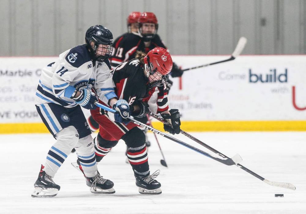 Thompson-Okanagan Lakers‘ Lily Roberts (14) plays against Winnipeg Avros‘ Liberty Aime (16) in the final. (John Woods / Winnipeg Free Press)