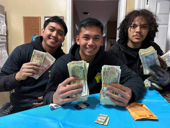 Duct Stories owner Earl Masanque, centre, with employees Jesse Bardaje, left, and Arthur Sanchez, found a decades-old can of Nestle's Quik blocking a customer's vent pipe with more than $4,000 in dollar bills stuffed inside. (Supplied)
