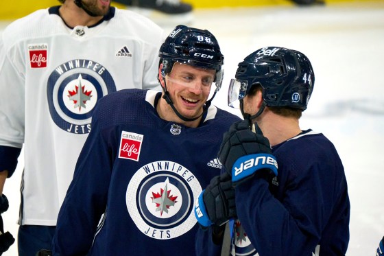 Nate Schmidt, centre, and Josh Morrissey, right, shared a laugh during practice at Canada Life Centre recently. Schmidt has chipped in a goal and three points during his past five games. (Mike Deal / Winnipeg Free Press files)