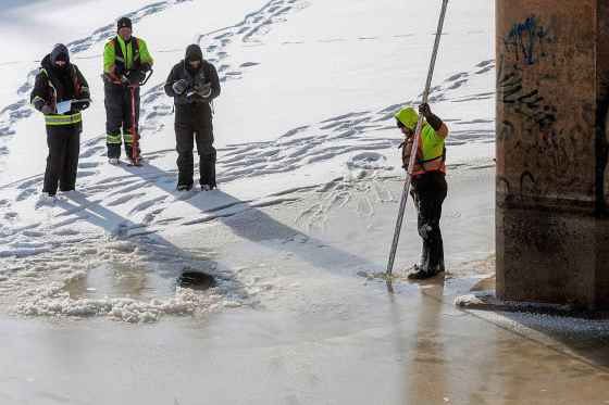 A crew from Dominion Divers checks the condition of ice on the the Assiniboine River underneath the Maryland Street Bridge on Tuesday afternoon. The Forks has not opened any of its river skating trails because the ice on the city's rivers isn’t thick enough — but frigid weather is in the forecast for coming days. (Mike Deal / Winnipeg Free Press)