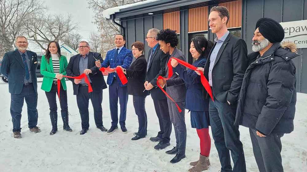 Premier Wab Kinew, members of his government and local officials cut the ribbon at the Neepawa Training Centre for nurses on Monday. From left: Neepawa deputy mayor Murray Parrott, Advanced Education and Training Minister Renée Cable, Assiniboine Community College president and CEO Mark Frison, Kinew, Town of Neepawa CAO Colleen Synchyshyn, Neepawa Mayor Brian Hedley, Health Minister Uzoma Asagwara, Fort Richmond MLA Jennifer Chen, Waverly MLA David Pankratz and Burrows MLA Diljeet Brar. (Miranda Leybourne/The Brandon Sun)