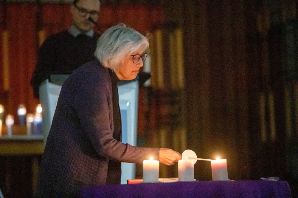 BROOK JONES / WINNIPEG FREE PRESS
Rev. Helen Holbrook, who is the chaplain at St. John's College, lights a candle during a vigil for Afolabi Stephen Opaso.