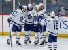 Toronto Maple Leafs' Auston Matthews (34), Simon Benoit (2), Jake McCabe (22), Matthew Knies (23) and Mitchell Marner (16) celebrate Benoit's goal during third period NHL action against the Winnipeg Jets in Winnipeg on Saturday, January 27, 2024. THE CANADIAN PRESS/John Woods
