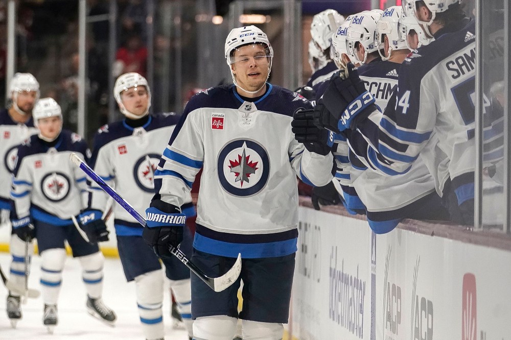 Winnipeg Jets Vladislav Namestnikov (7) gets high-fives from his bench after scoring a goal during the first period. (Darryl Webb / The Associated Press)