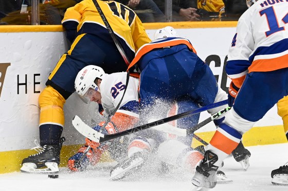 New York Islanders' Mike Reilly (2) skates into teammate Sebastian Aho (25) as they both go for the puck against Nashville Predators centre Colton Sissons (10) during the second period on Jan. 13 in Nashville, Tenn. (Mark Zaleski / The Associated Press files)