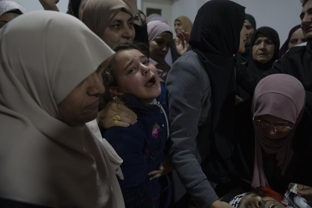 Mourners take the last look at the body of Ziad Da'meh, 39, during his funeral in the West Bank refugee camp of Nour Shams, Tulkarem, Thursday, Feb. 8, 2024. Palestinian health ministry said that Two Palestinians were killed during an Israeli army operation in the refugee camp on Wednesday. (AP Photo/Nasser Nasser)