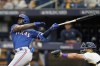 FILE - Texas Rangers' Adolis Garcia, left, bats against the Tampa Bay Rays during Game 1 in an AL wild-card baseball playoff series Oct. 3, 2023, in St. Petersburg, Fla. The World Series champion Rangers finalized deals Friday, Jan. 26, 2024, with veteran reliever David Robertson and outfielder Travis Jankowski, but still have no agreement with AL Championship Series MVP García in advance of salary arbitration hearings. (AP Photo/John Raoux, File)