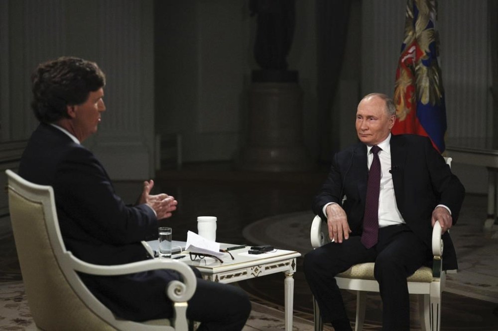 In this photo released by Sputnik news agency on Friday, Feb. 9, 2024, Russian President Vladimir Putin, right, attends an interview with former Fox News host Tucker Carlson at the Kremlin in Moscow, Russia, Tuesday, Feb. 6, 2024. (Gavriil Grigorov/Sputnik, Kremlin, Pool Photo via AP)