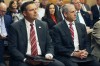 Kansas Attorney General Kris Kobach, left, follows a legislative committee hearing, Wednesday, Feb. 7, 2024, at the Statehouse in Topeka, Kan., with lobbyist Whitney Damron, right, sitting next to him. Kobach is telling public school districts that it is an improper violation of parents' rights not to tell them if their children are presenting as non-binary or socially transitioning away from the gender assigned at birth, while at school. (AP Photo/John Hanna)