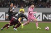 Inter Miami's Lionel Messi, right, battles for the ball against Vissel Kobe's Nanasei Iino during the friendly soccer match between Vissel Kobe and Inter Miami CF at the National Stadium, Wednesday, Feb. 7, 2024, in Tokyo, Japan. (AP Photo/Eugene Hoshiko)