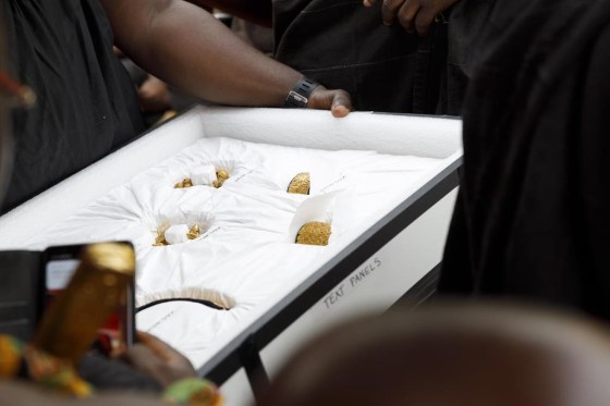 Artefacts returned from UCLA's Fowler museum are carried to Asante King Otumfuo Osei Tutu II at the Manhyia Palace in Kumasi, Ghana, Thursday. (Misper Apawu / The Associated Press)
