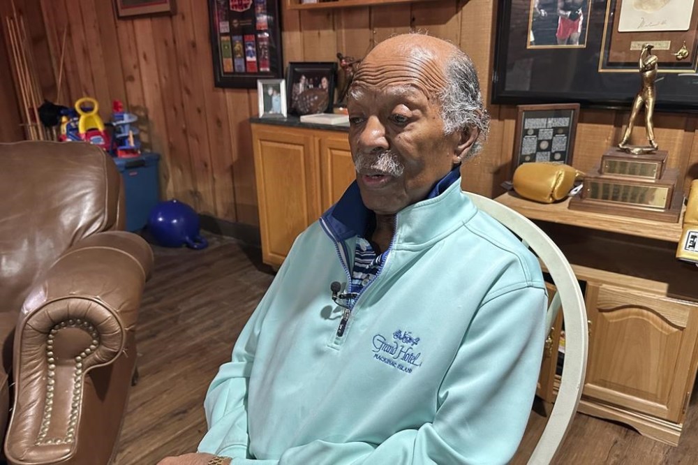 Gregory Eaton sits in a chair during an interview at his home, Tuesday, Jan. 30, 2024 in Lansing, Mich. Eaton is a member of the exclusive