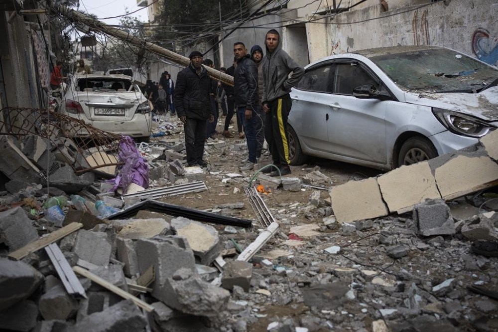 Palestinians look at the destruction after an Israeli airstrike in Rafah, Gaza SAtrip, Friday, Feb. 9, 2024. (AP Photo/Fatima Shbair)