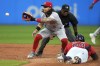 FILE - Cincinnati Reds second baseman Jonathan India, left, gets the throw in time to tag out Cleveland Guardians' Josh Naylor, bottom right, at second on a steal-attempt during the third inning of a baseball game Sept. 27, 2023, in Cleveland. India has signed a new two-year contract, avoiding arbitration, the team announced Friday, Feb. 9, 2024. (AP Photo/Sue Ogrocki, File)